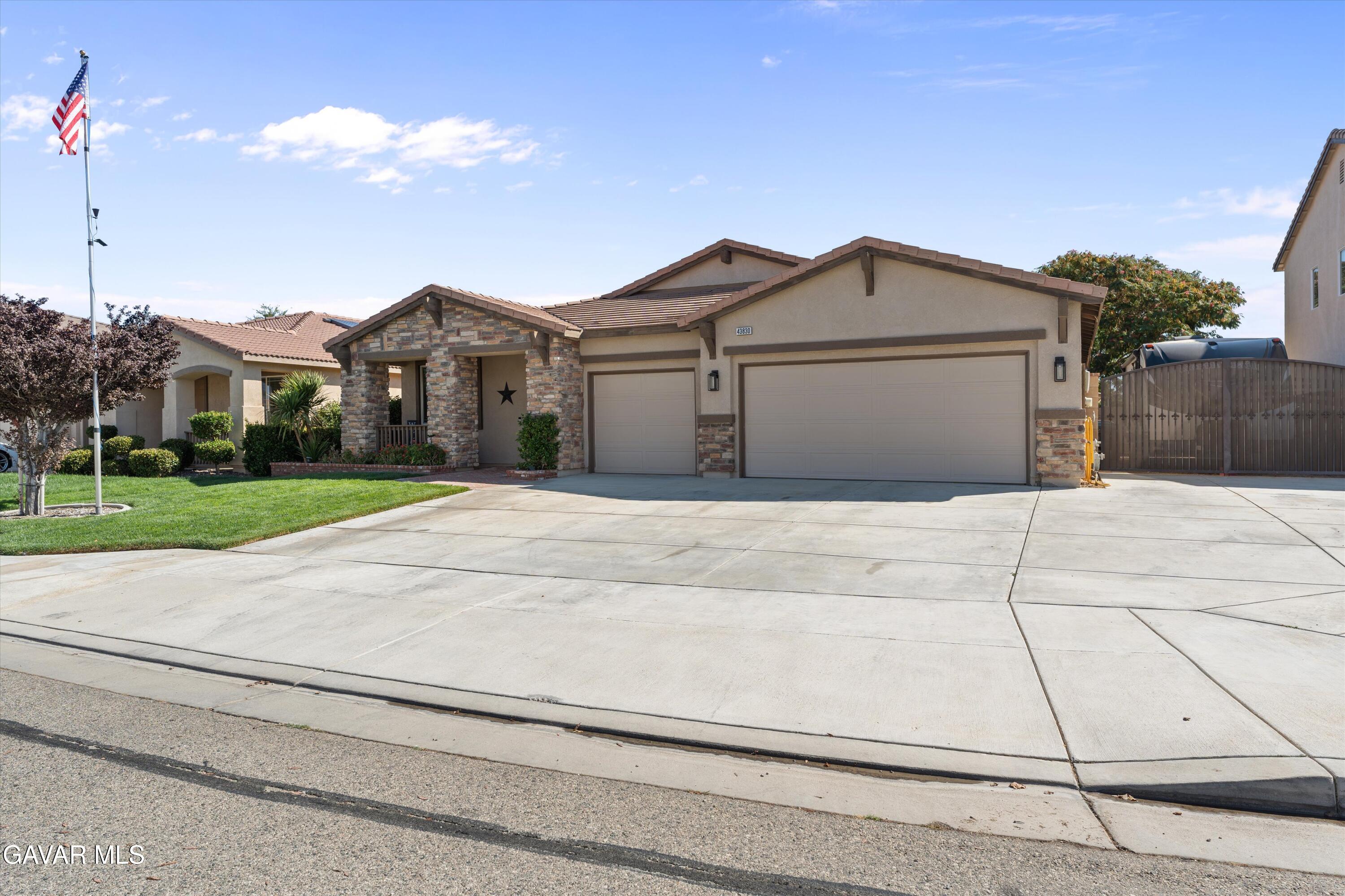 43830 Elena Court Lancaster, CA 93536 - Photo 4 of 22 a view of a house next to a yard