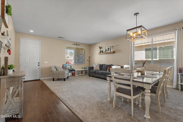a living room with furniture a dining table and chairs