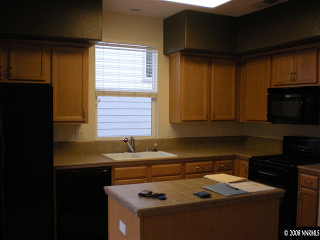 2165 Hellaby Lane Reno, NV 89502 - Photo 2 of 6 a kitchen with a sink a stove and cabinets