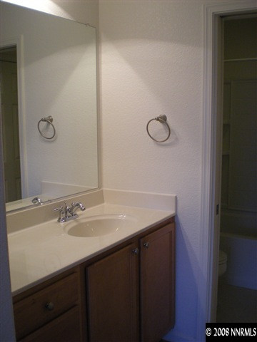 2165 Hellaby Lane Reno, NV 89502 - Photo 6 of 6 a bathroom with a sink vanity and a mirror