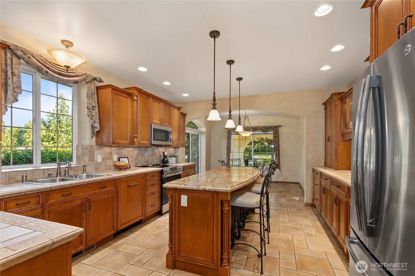 1788 Matz Road Ferndale, WA 98248 - Photo 14 of 40 a kitchen with stainless steel appliances granite countertop a sink a stove and a refrigerator