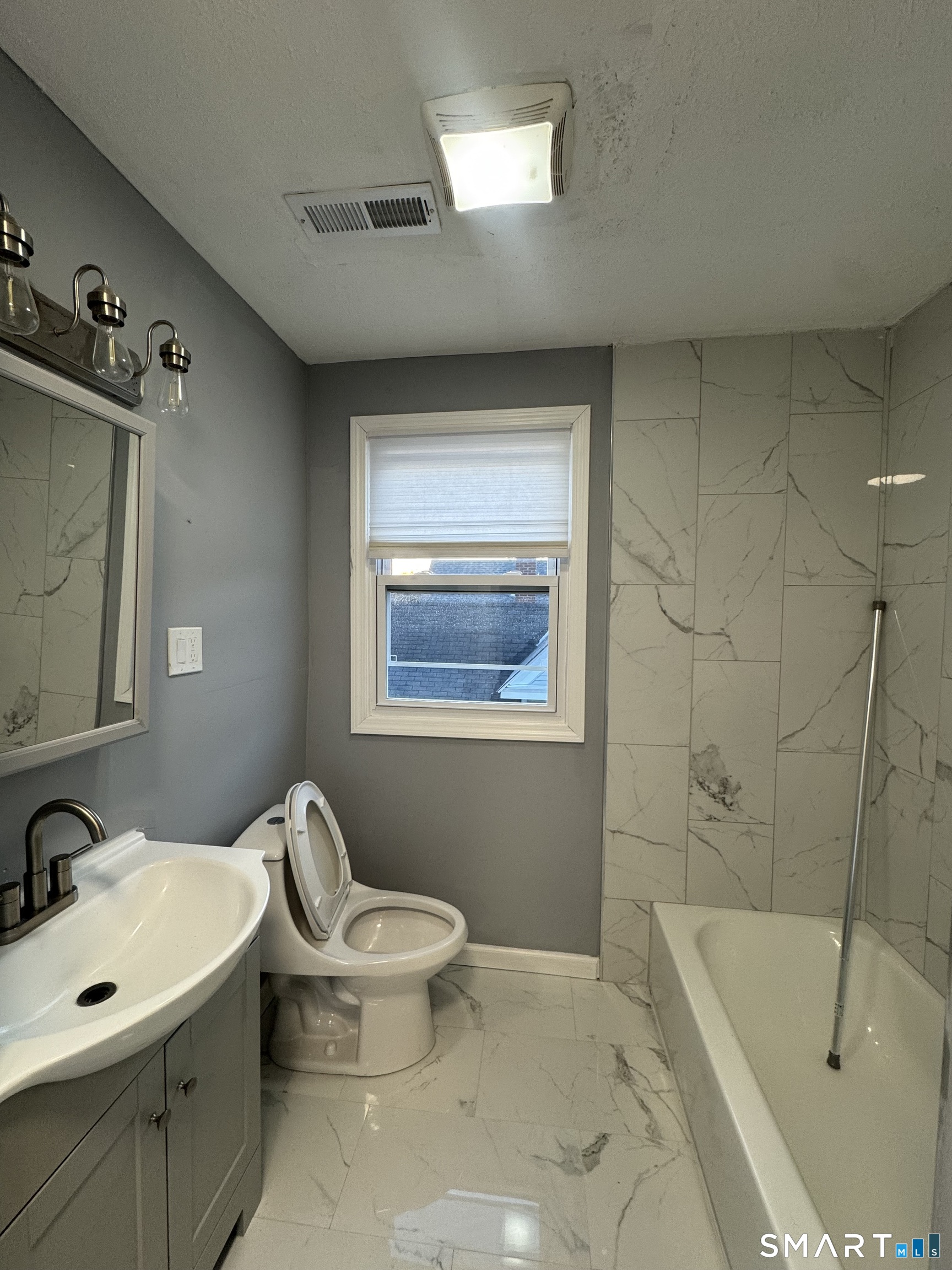10 Lester Street, Unit 3 West Haven, CT 06516 - Photo 3 of 10 a bathroom with a sink mirror toilet and bathtub