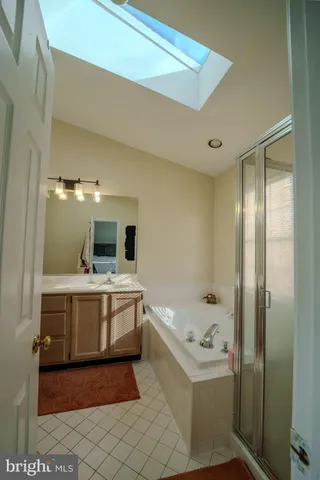a view of a bathroom with sink bath tub and shower