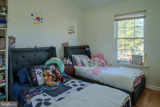 a bedroom with bed and a window