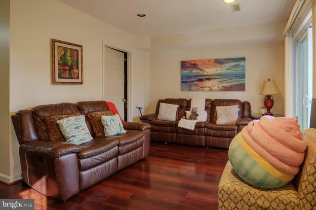 a living room with furniture rug and wooden floor