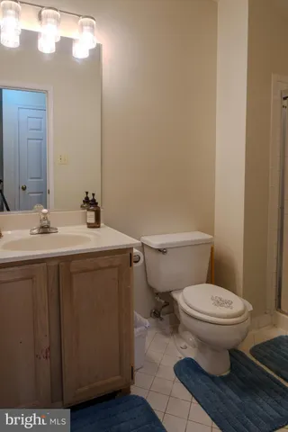a bathroom with a sink toilet and a mirror