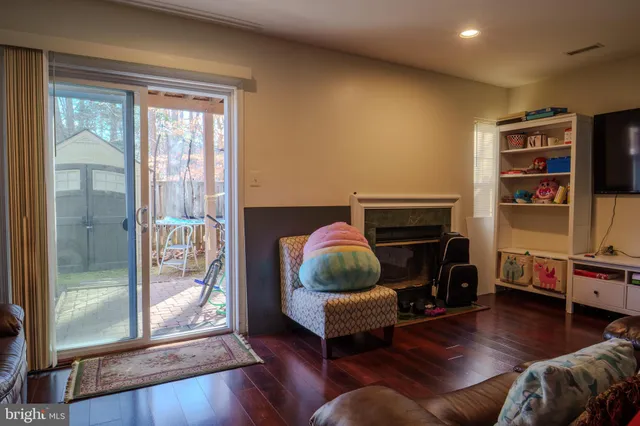 a living room with furniture a ceiling fan and a wooden floor