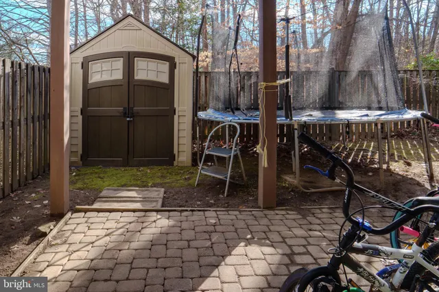 a brick building with a bench and a table