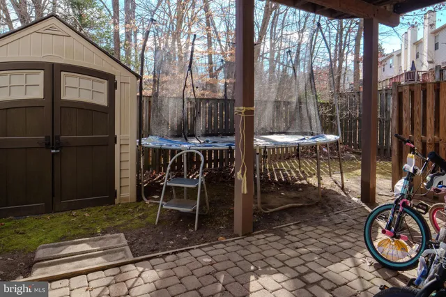 a backyard of a house with barbeque oven table and chairs