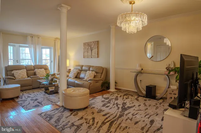 a living room with furniture a flat screen tv and a window