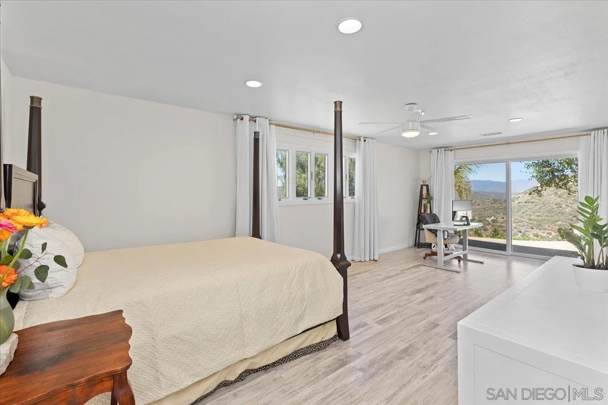 20403 Rancho Villa Road Ramona, CA 92065 - Photo 11 of 66 a bedroom with a bed a table and chairs