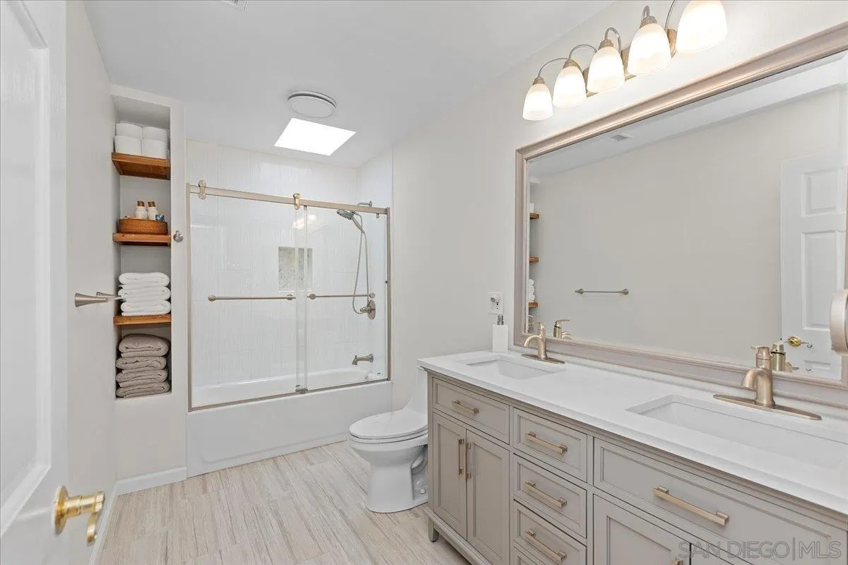 20403 Rancho Villa Road Ramona, CA 92065 - Photo 12 of 66 a spacious bathroom with a granite countertop sink a toilet a mirror and shower