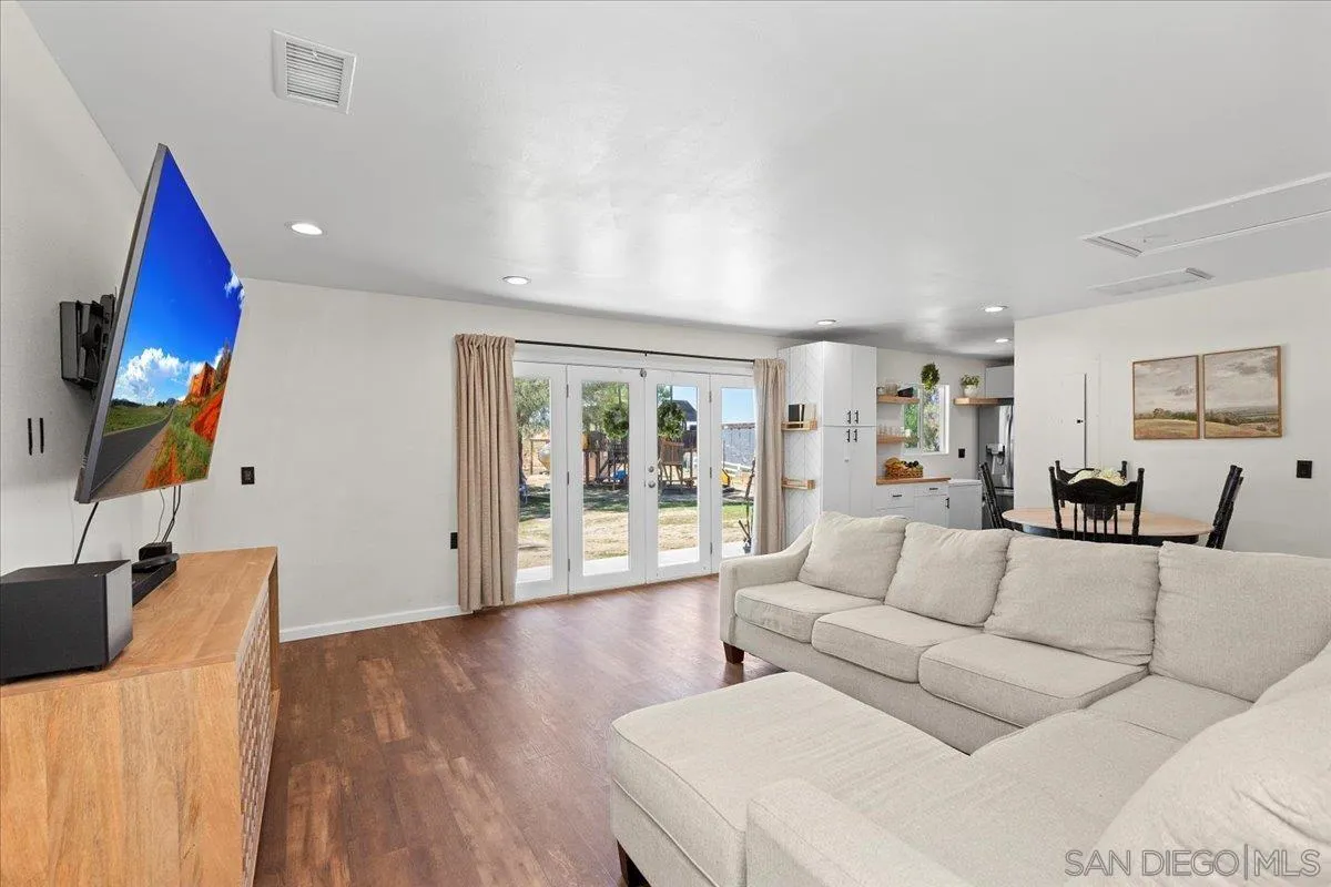 20403 Rancho Villa Road Ramona, CA 92065 - Photo 14 of 66 a living room with furniture a wooden floor and a large window