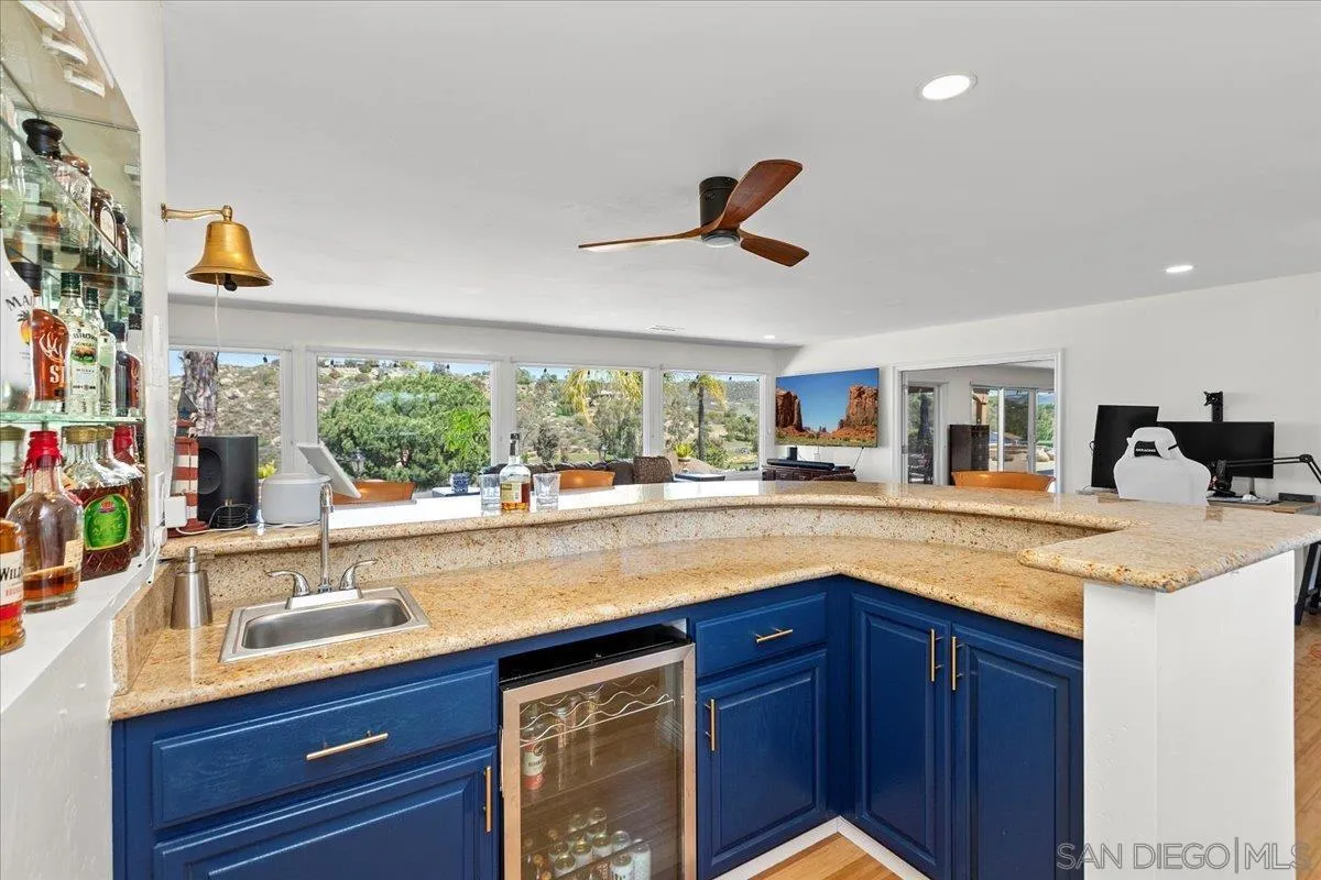 20403 Rancho Villa Road Ramona, CA 92065 - Photo 21 of 66 a kitchen with granite countertop a sink and a wooden floor