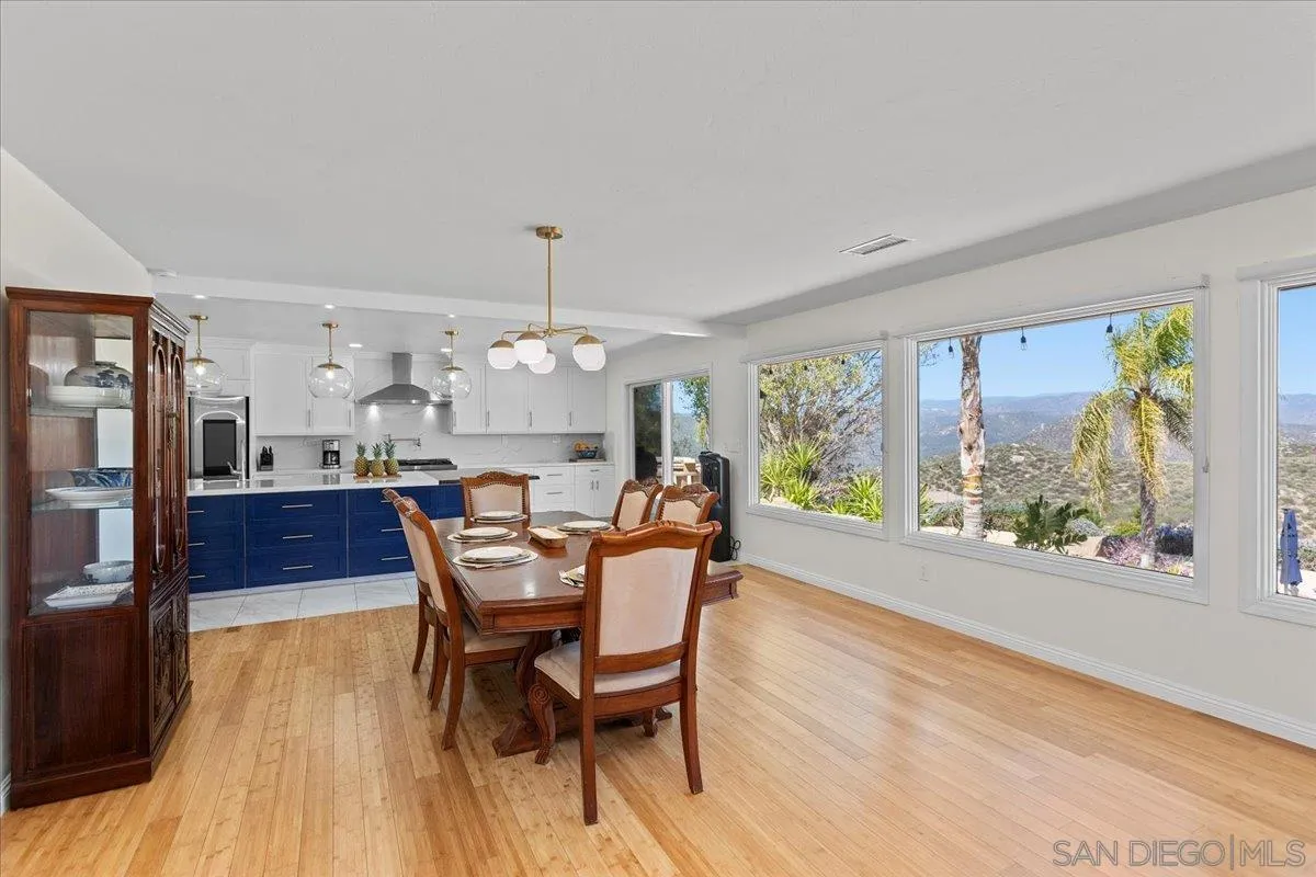 20403 Rancho Villa Road Ramona, CA 92065 - Photo 23 of 66 a dining room with furniture a rug and a floor to ceiling window