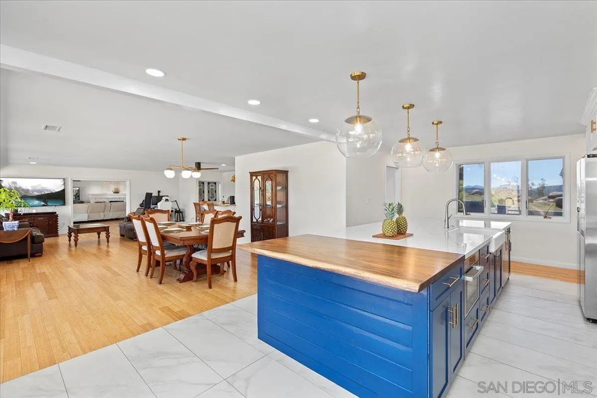 20403 Rancho Villa Road Ramona, CA 92065 - Photo 24 of 66 a large kitchen with kitchen island a sink table and chairs