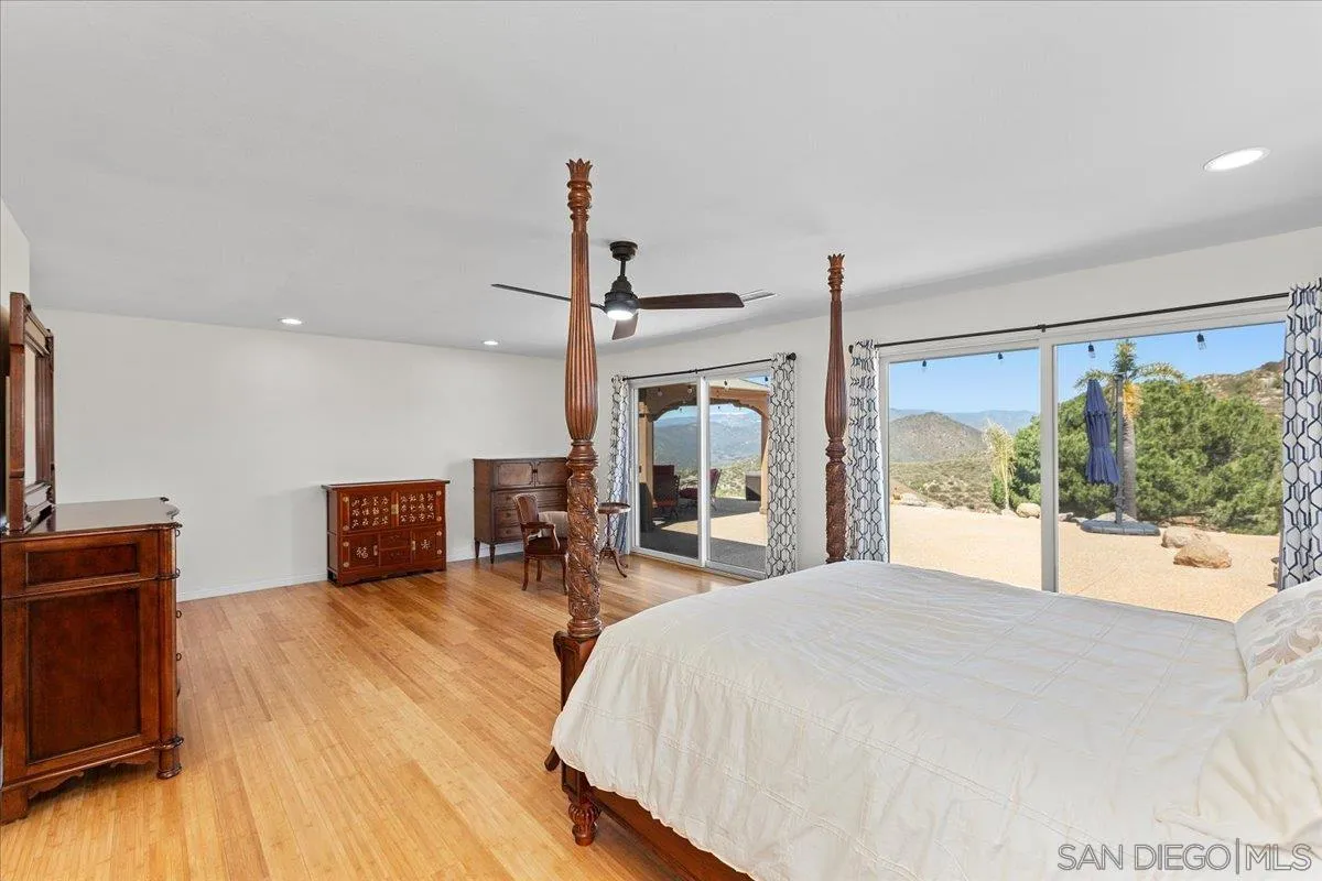 20403 Rancho Villa Road Ramona, CA 92065 - Photo 29 of 66 a bed room with a bed and glass window