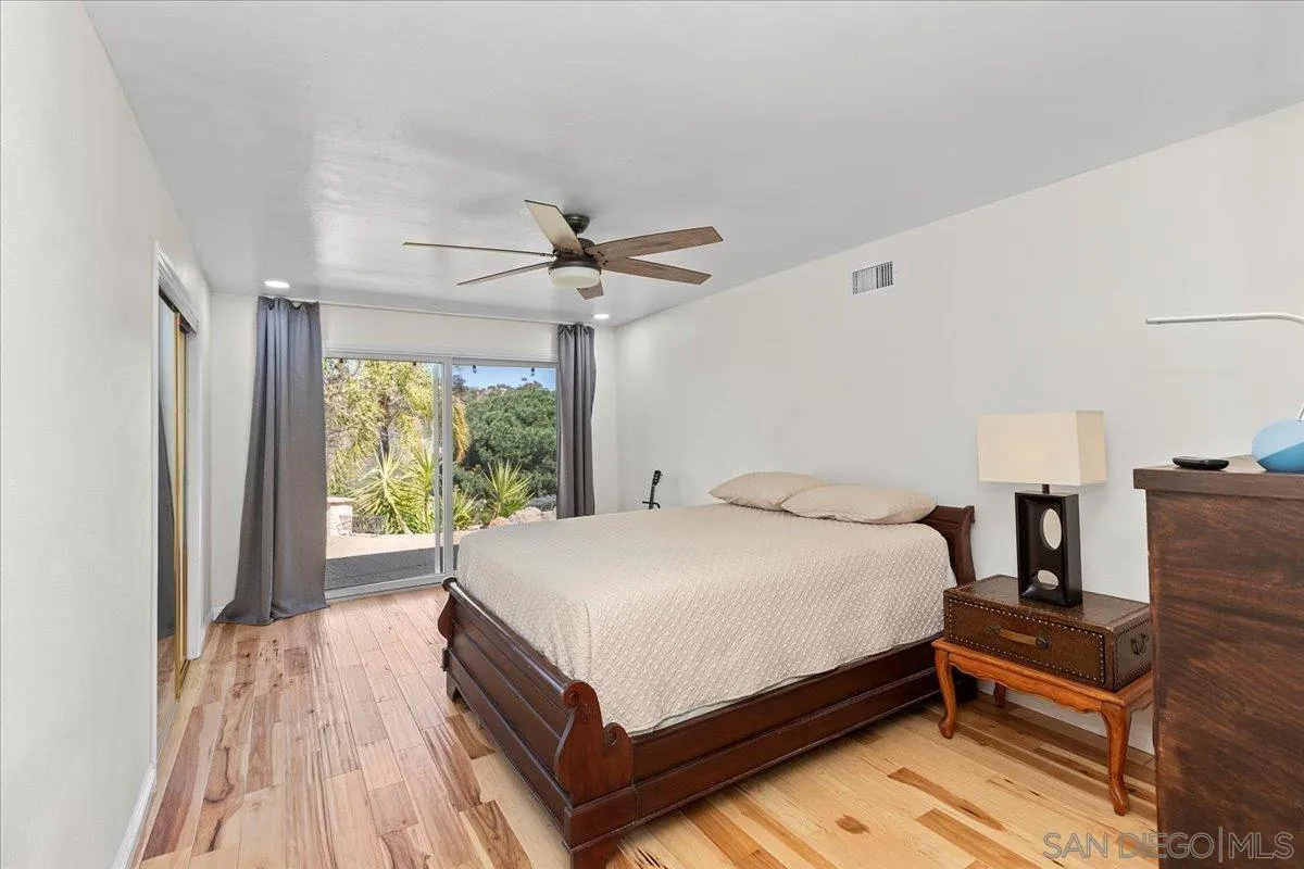20403 Rancho Villa Road Ramona, CA 92065 - Photo 32 of 66 a bed sitting in a spacious bedroom next to a window