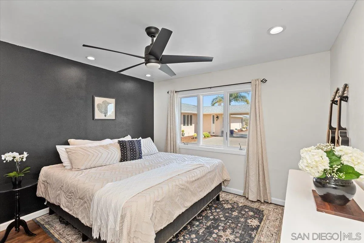 20403 Rancho Villa Road Ramona, CA 92065 - Photo 40 of 66 a bedroom with a bed chandelier and a window