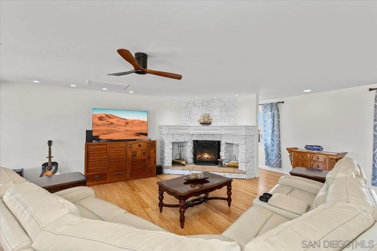 20403 Rancho Villa Road Ramona, CA 92065 - Photo 6 of 66 a living room with furniture a rug and a fireplace