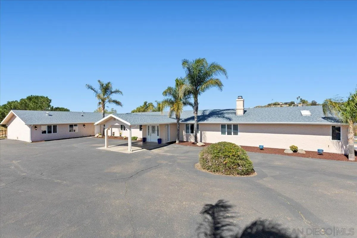 20403 Rancho Villa Road Ramona, CA 92065 - Photo 66 of 66 a front view of a house with a yard and garage