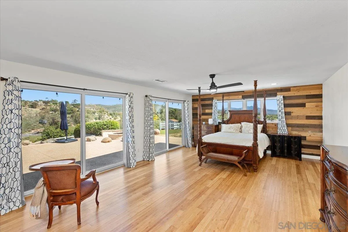 20403 Rancho Villa Road Ramona, CA 92065 - Photo 9 of 66 a bedroom with a bed and wooden floor