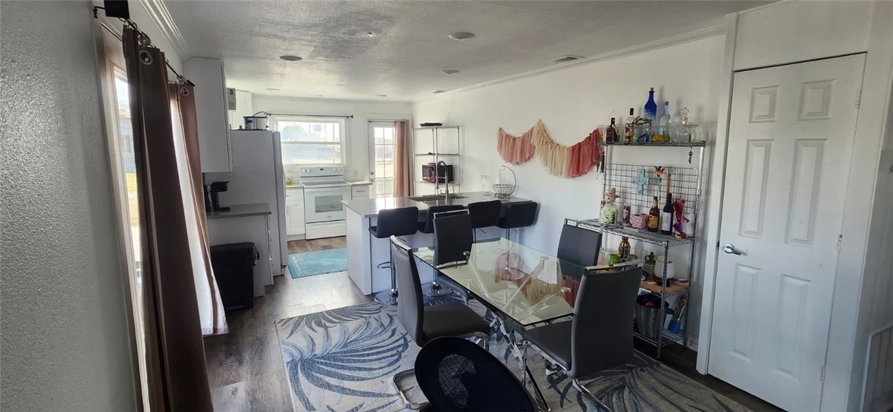 1407 Dema Street Corpus Christi, TX 78418 - Photo 11 of 19 a view of a dining room with furniture window and wooden floor