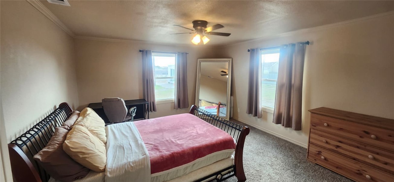 1407 Dema Street Corpus Christi, TX 78418 - Photo 15 of 19 a bedroom with a bed and a chandelier