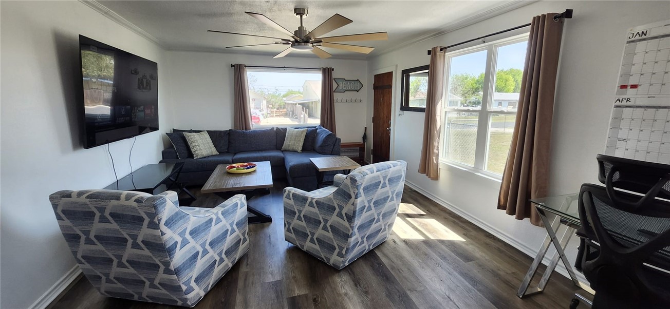 1407 Dema Street Corpus Christi, TX 78418 - Photo 9 of 19 a living room with furniture a flat screen tv and a large window