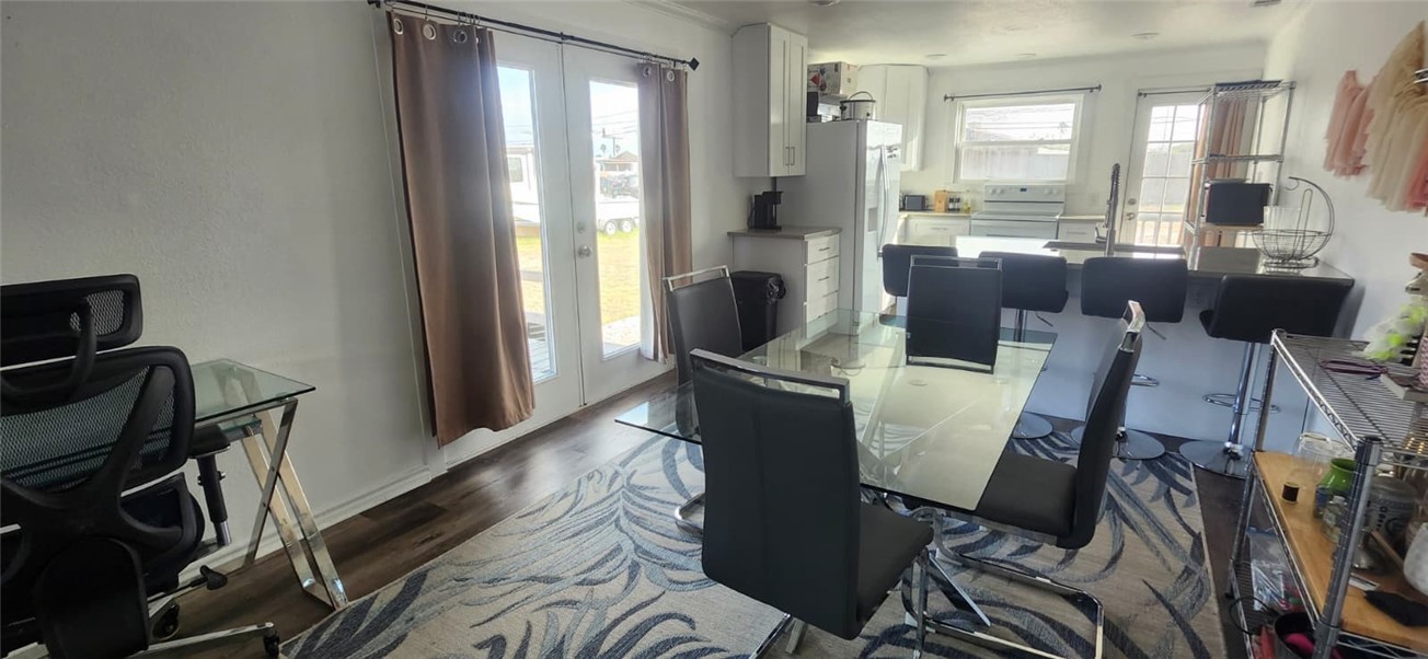 1407 Dema Street Corpus Christi, TX 78418 - Photo 10 of 19 a view of a dining room with furniture window and wooden floor