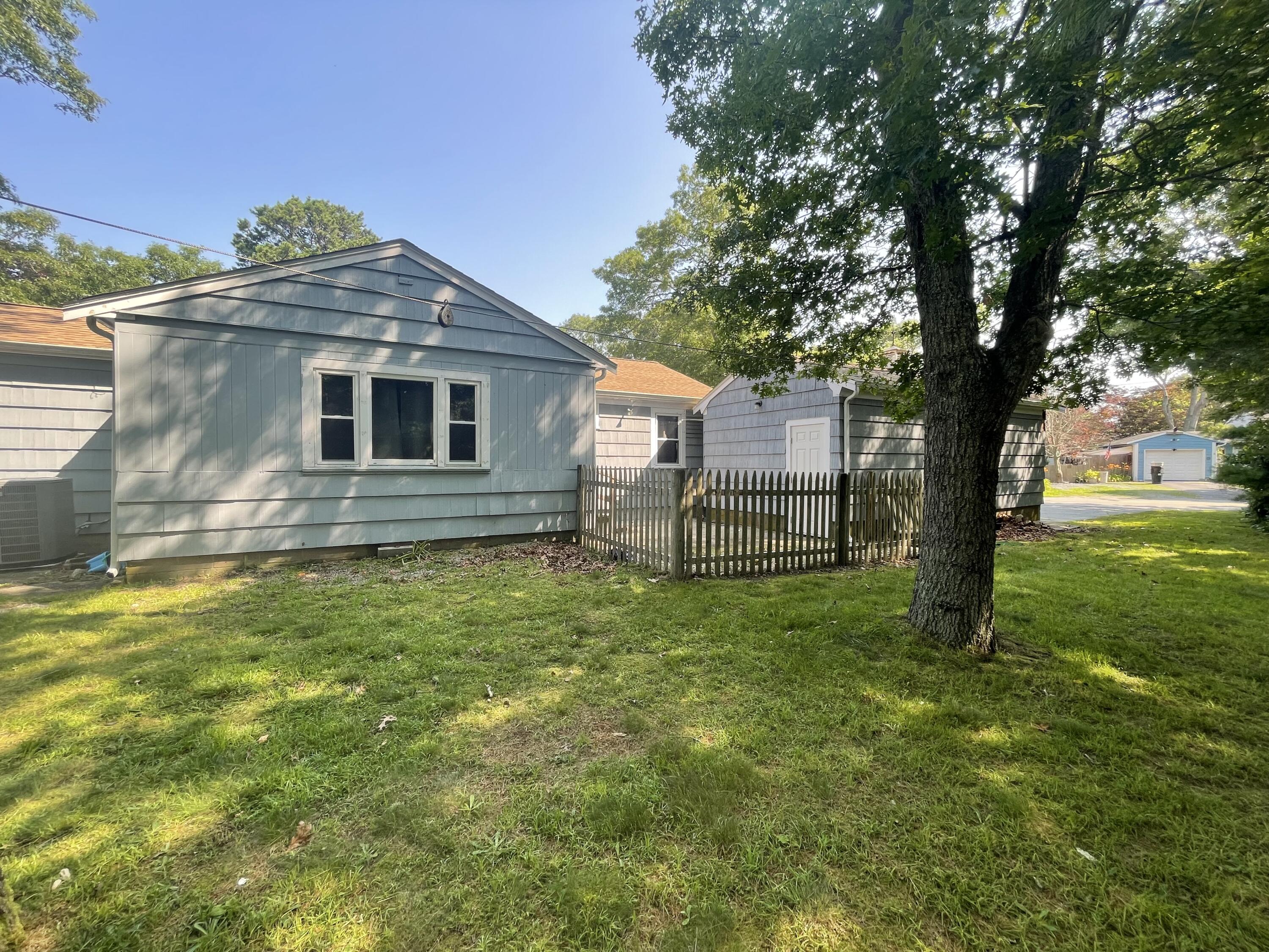 358 Strawberry Hill Road Centerville, MA 02632 - Photo 2 of 11 a front view of a house with a yard