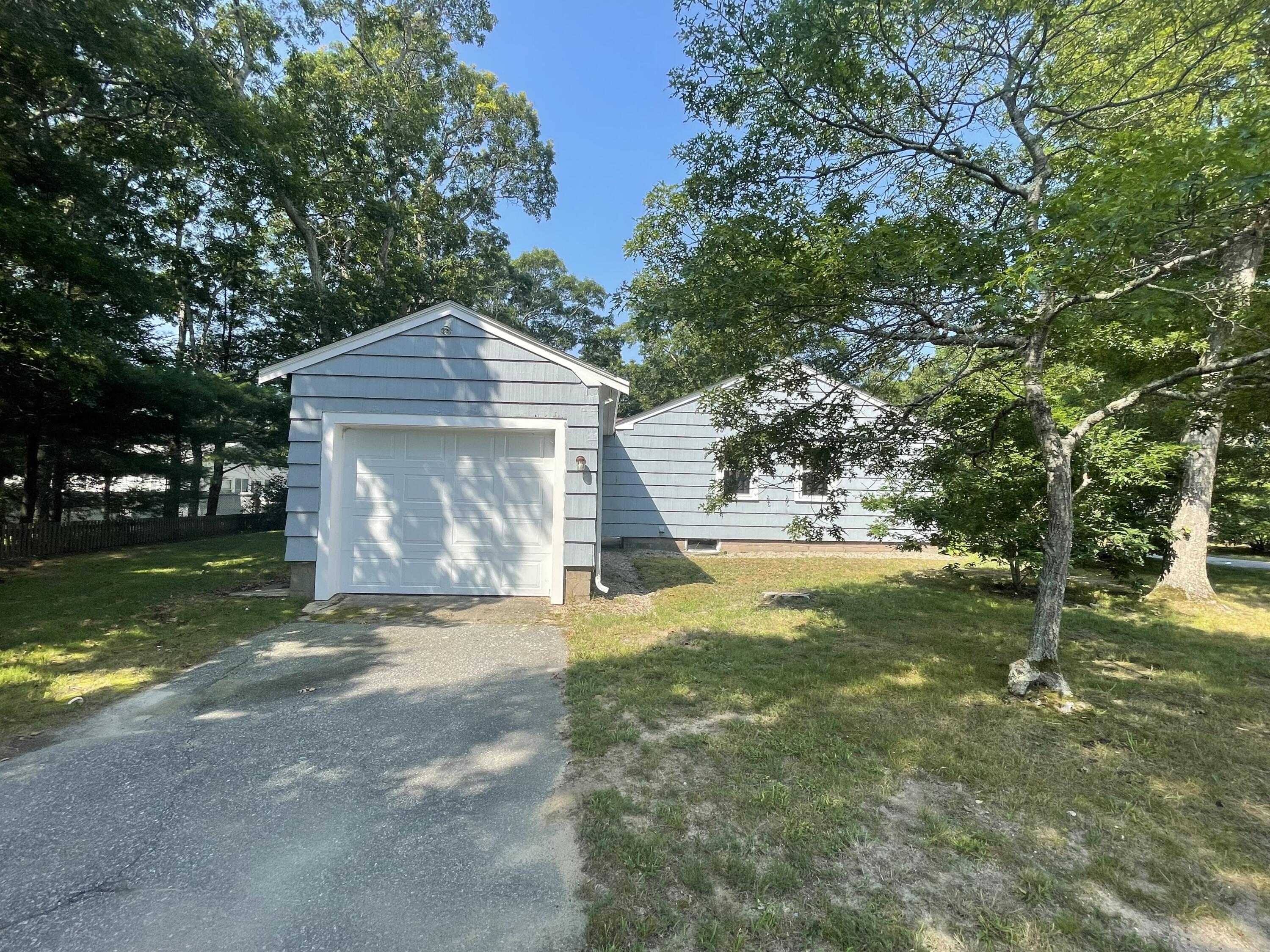 358 Strawberry Hill Road Centerville, MA 02632 - Photo 3 of 11 a view of a house with a yard garage and sitting area