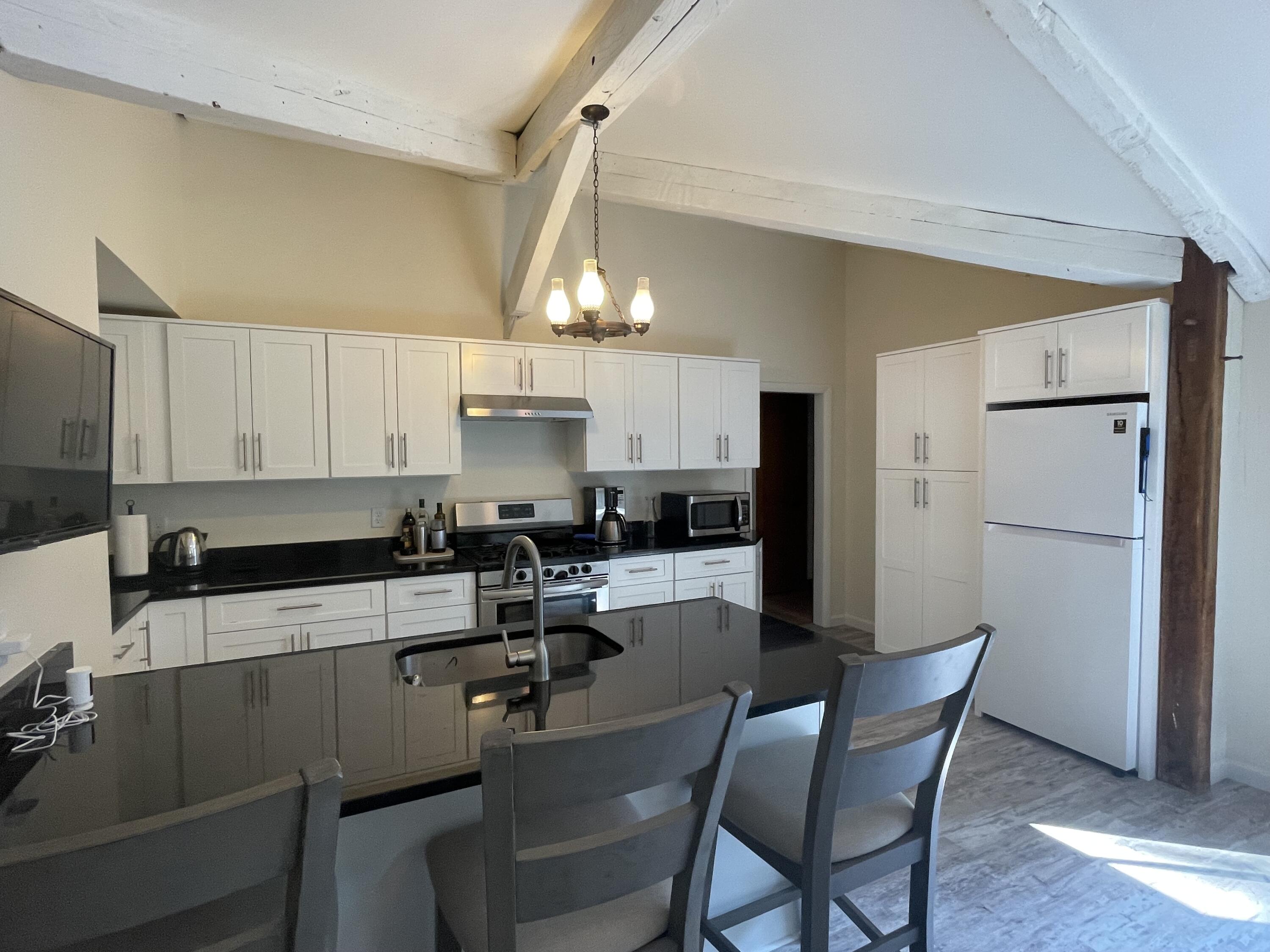 358 Strawberry Hill Road Centerville, MA 02632 - Photo 4 of 11 a kitchen with a sink cabinets and refrigerator