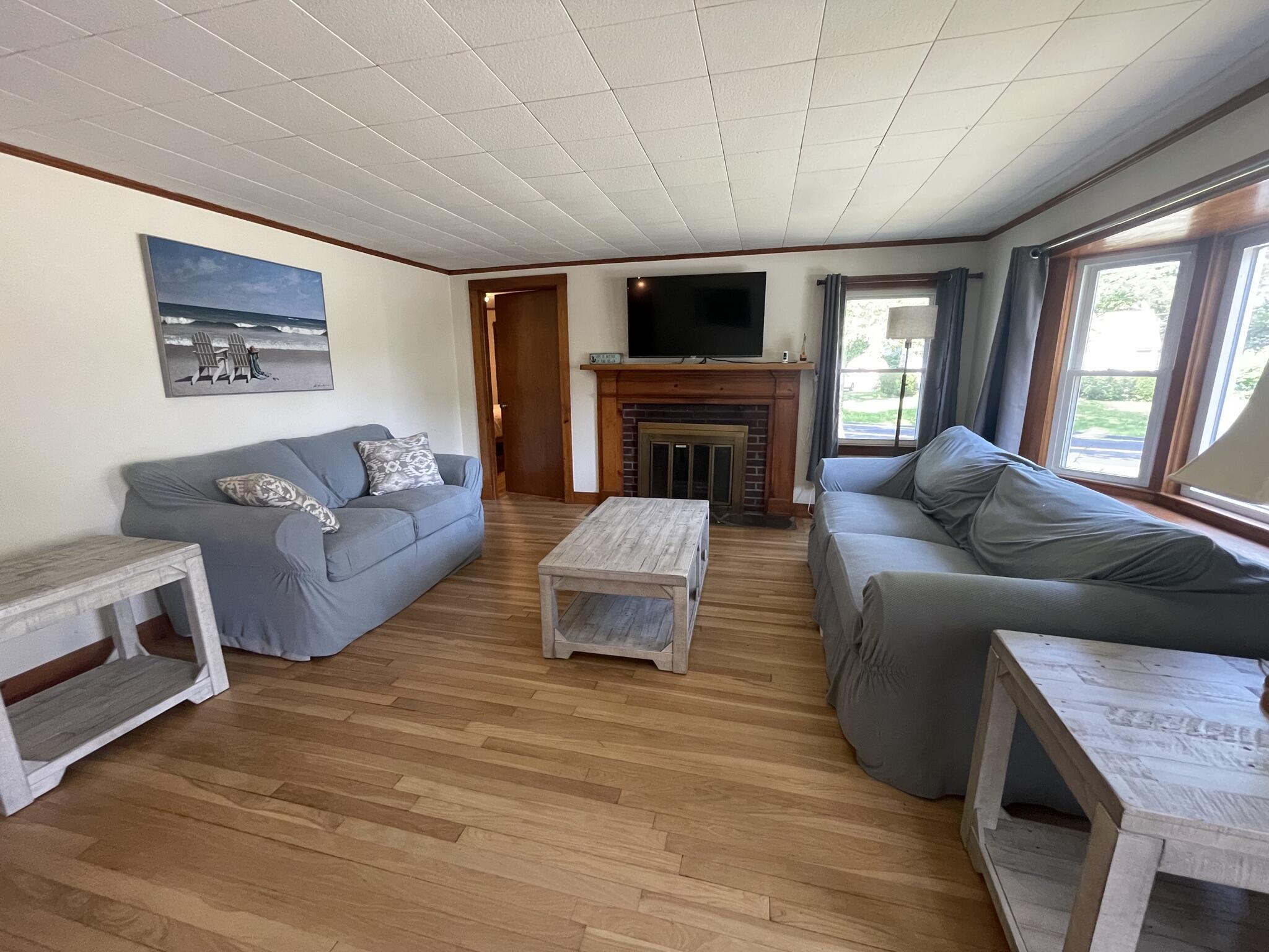 358 Strawberry Hill Road Centerville, MA 02632 - Photo 7 of 11 a living room with furniture and a fireplace