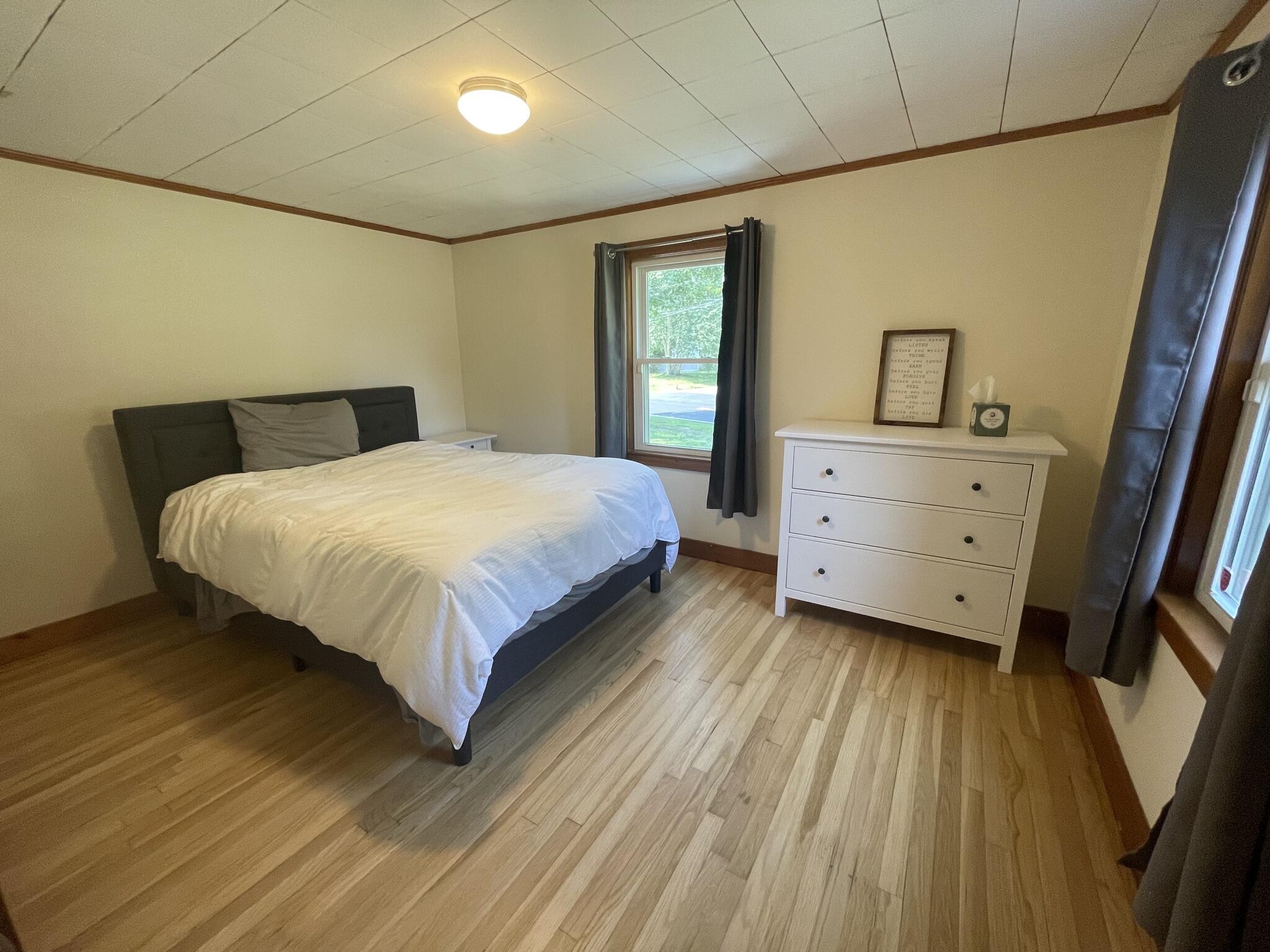 358 Strawberry Hill Road Centerville, MA 02632 - Photo 8 of 11 a bedroom with a bed and a mirror on the dresser