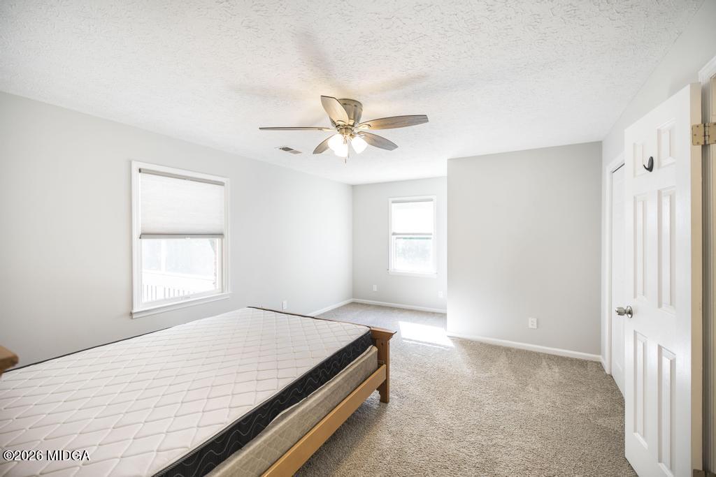 3365 Highway 80 Roberta, GA 31078 - Photo 15 of 41 an empty room with windows and ceiling fan