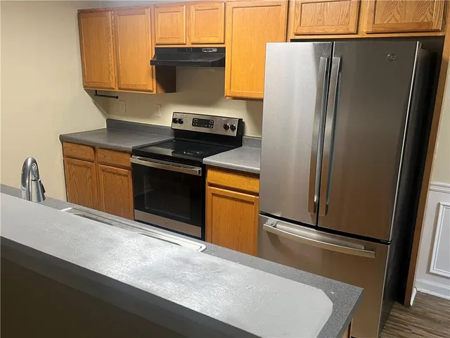 a kitchen with stainless steel appliances a refrigerator stove and sink