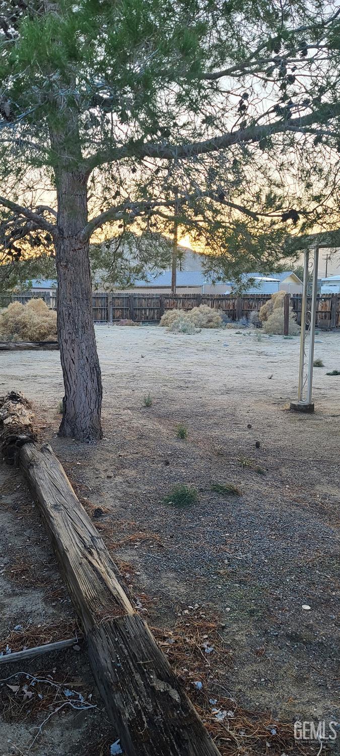 Undisclosed Address Trona, CA 93562 - Photo 27 of 27 a view of a yard with wooden fence
