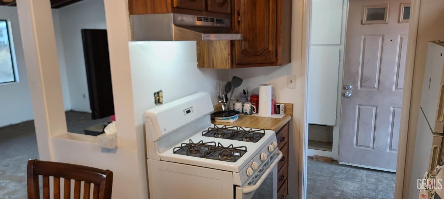 Undisclosed Address Trona, CA 93562 - Photo 7 of 27 a kitchen with a stove and a refrigerator