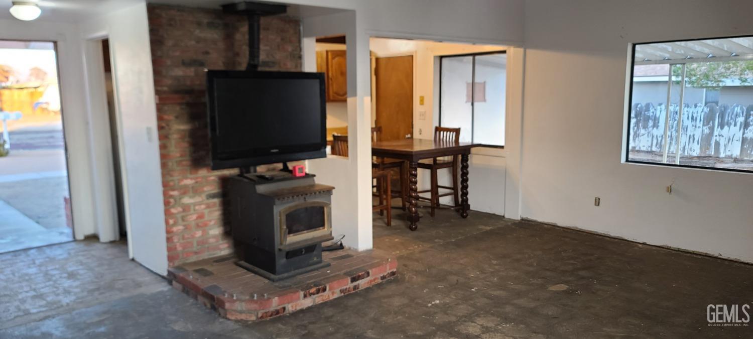 Undisclosed Address Trona, CA 93562 - Photo 9 of 27 a living room with fireplace furniture and a flat screen tv