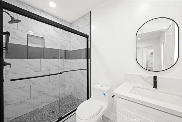 a bathroom with a sink a toilet and a mirror