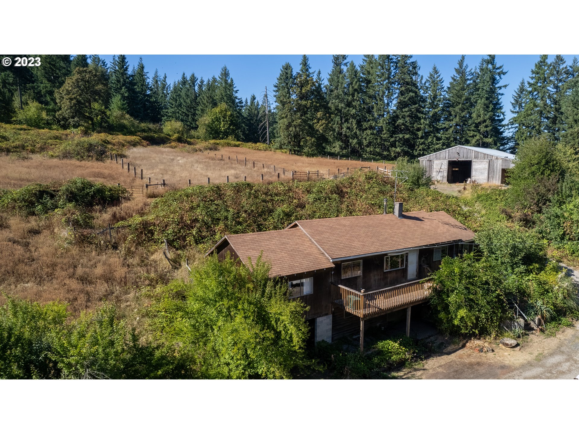 16913 South Hattan Road Oregon City, OR 97045 - Photo 26 of 44 a aerial view of a house with yard and trees in the background