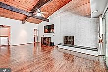 3604 Barberry Court Baltimore, MD 21208 - Photo 22 of 48 a view of a livingroom with a fireplace and a ceiling fan
