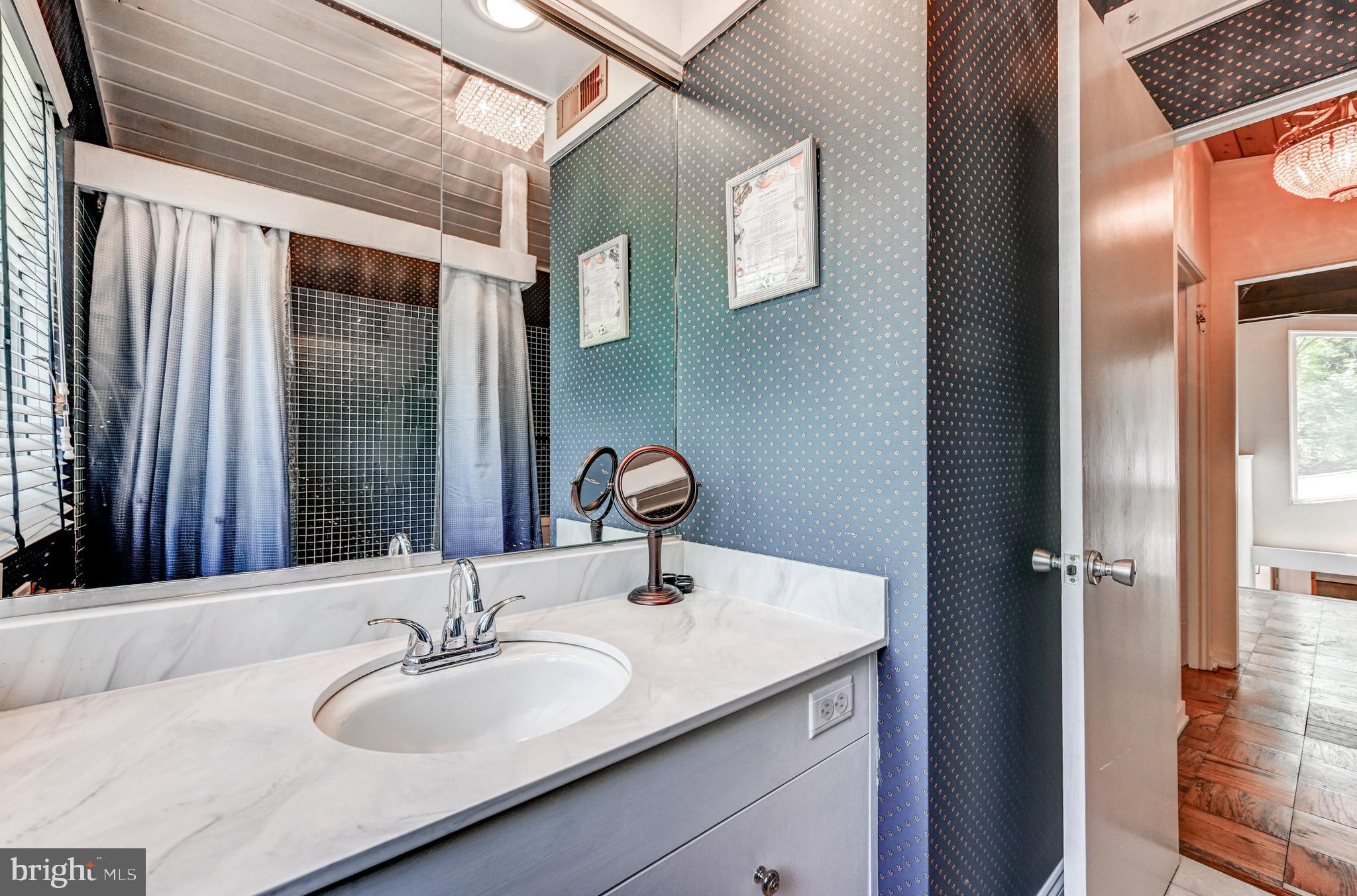 3604 Barberry Court Baltimore, MD 21208 - Photo 35 of 48 a bathroom with a sink and a mirror