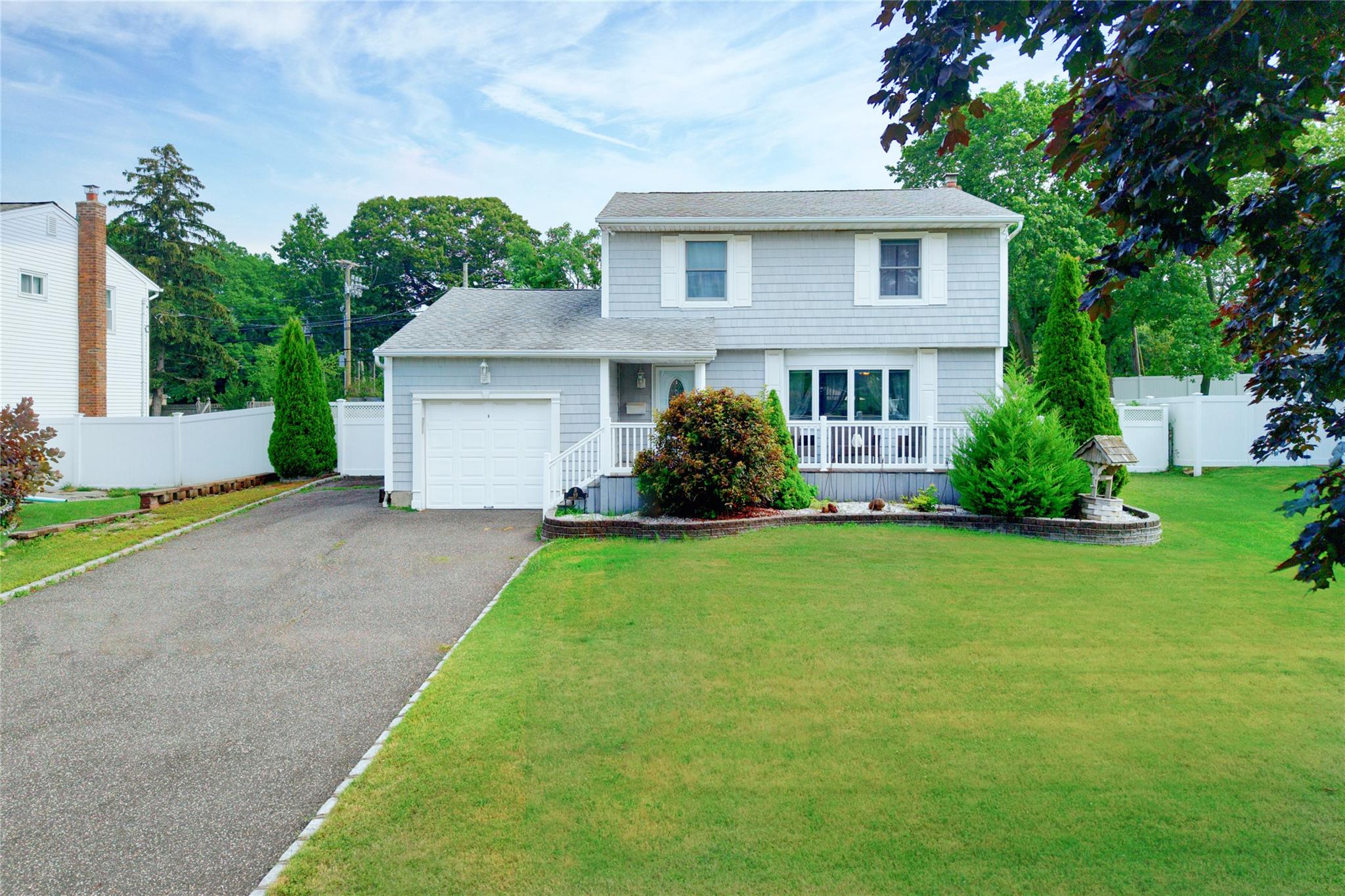 69 Rumford Road Kings Park, NY 11754 - Photo 1 of 1 View of front of property with a garage and asphalt driveway