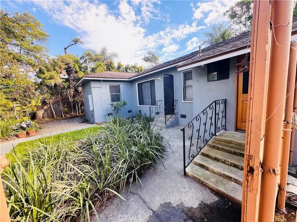 a view of a house with wooden fence