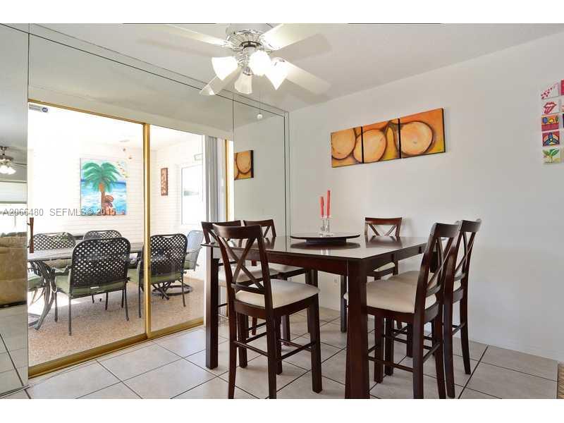 5010 West Park Road Hollywood, FL 33021 - Photo 4 of 16 a view of a dining room and livingroom with furniture wooden floor and a chandelier