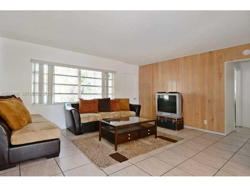 5010 West Park Road Hollywood, FL 33021 - Photo 5 of 16 a living room with furniture and a flat screen tv