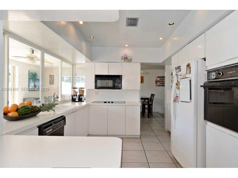 5010 West Park Road Hollywood, FL 33021 - Photo 6 of 16 a large white kitchen with lots of counter space and stainless steel appliances