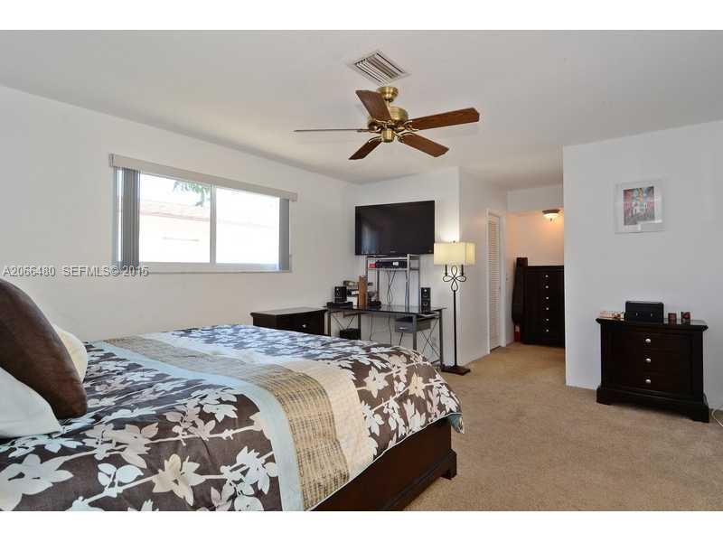 5010 West Park Road Hollywood, FL 33021 - Photo 8 of 16 a bedroom with a bed and a flat screen tv